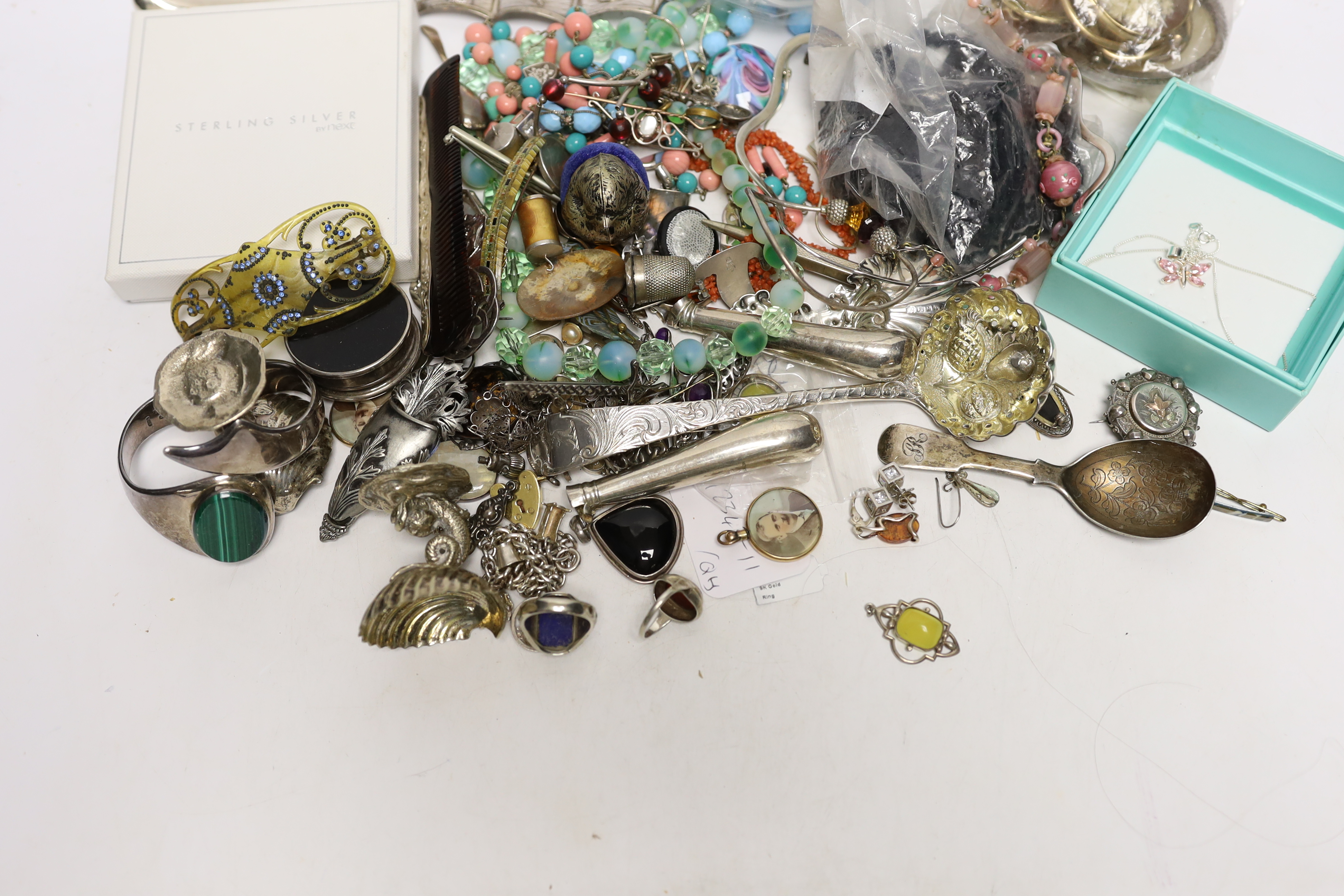 A quantity of assorted costume and other jewellery including a Charles Horner white metal and gem set brooch and sundry silver including two 19th century caddy spoons and a Georgian sifter spoon.